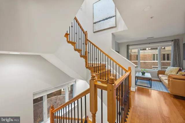 a view of a patio with couches chairs dining table and chairs with wooden floor