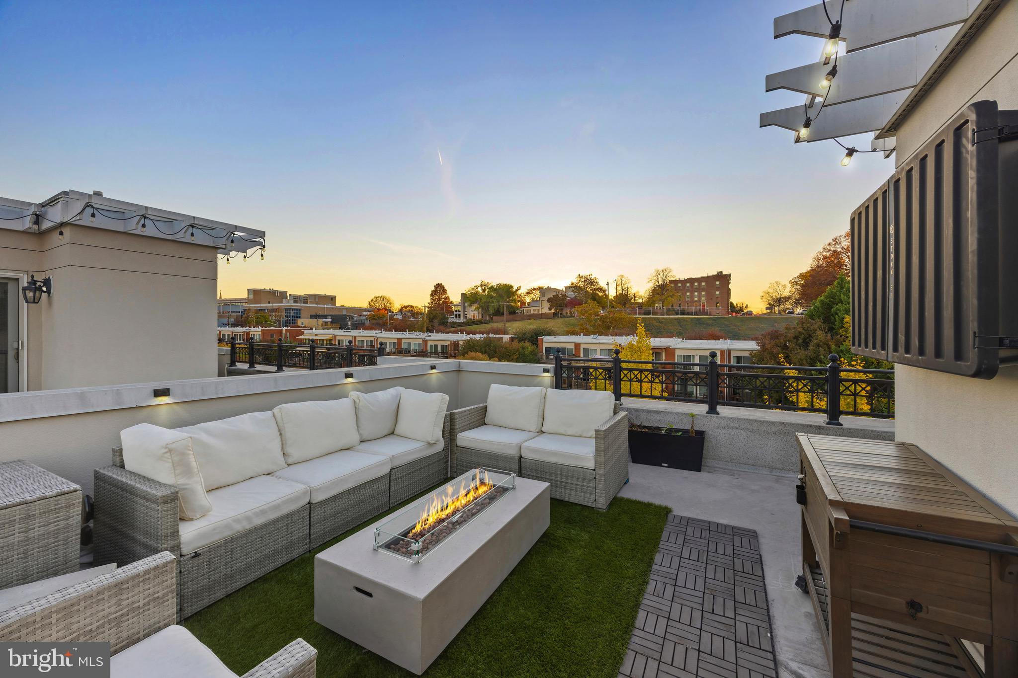 900 Valencia Court, Unit 188 Baltimore, MD 21230 - Photo 53 of 62 a roof deck with couches and potted plants with sky view