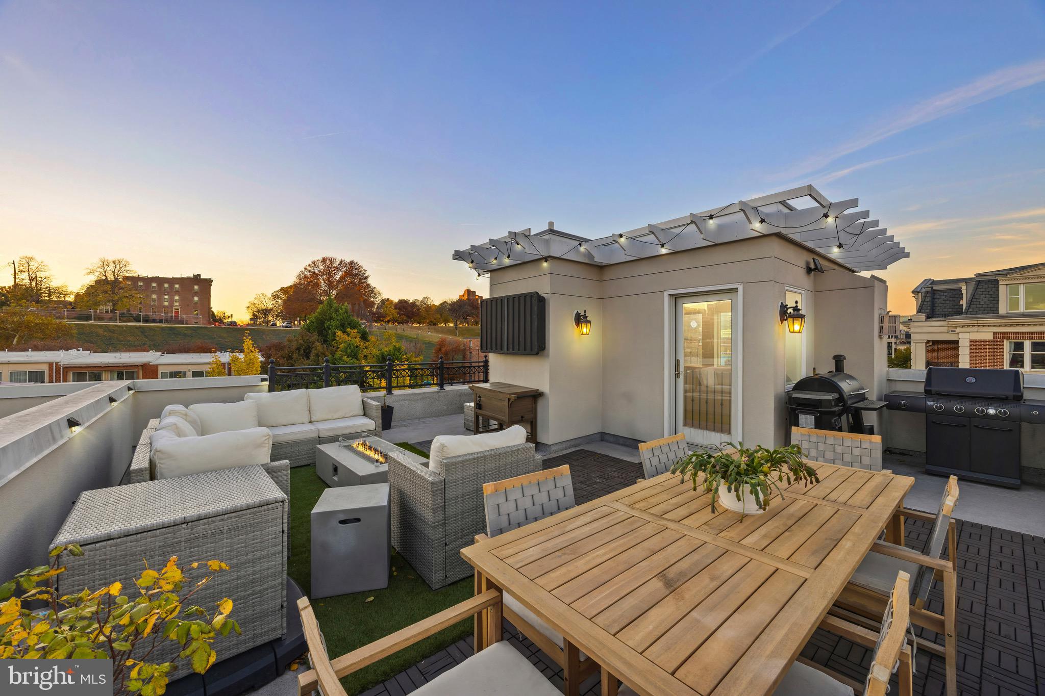 900 Valencia Court, Unit 188 Baltimore, MD 21230 - Photo 54 of 62 a view of a patio with couches table and chairs with wooden floor and fence