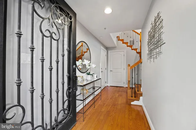 a kitchen with stainless steel appliances granite countertop a refrigerator a stove and a wooden floors