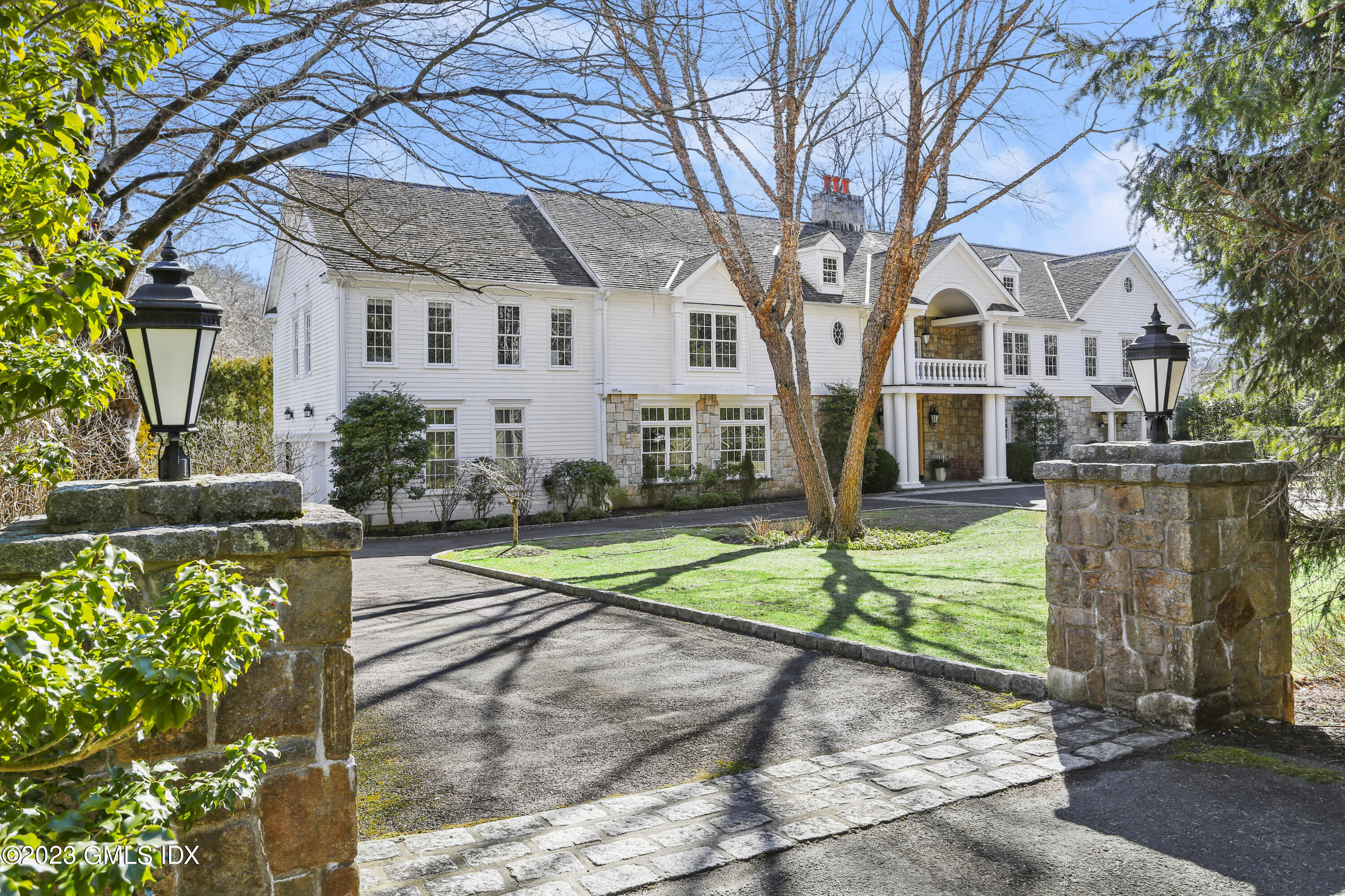 1 Butternut Hollow Road Greenwich, CT 06830 - Photo 1 of 1 a view of a white house with a yard