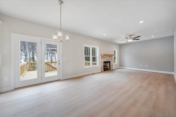 a view of livingroom with fireplace cabinet and windows