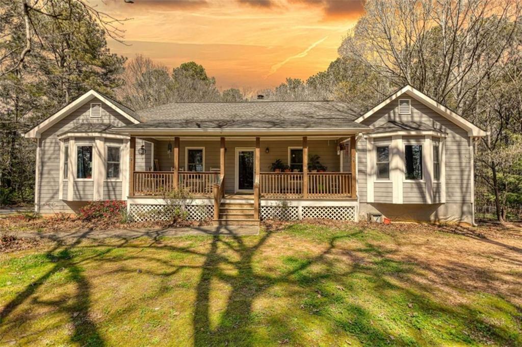 2740 Dennard Road Northeast Conyers, GA 30013 - Photo 1 of 51 a front view of a house with a garden