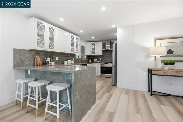 a kitchen with granite countertop stainless steel appliances a sink and counter space