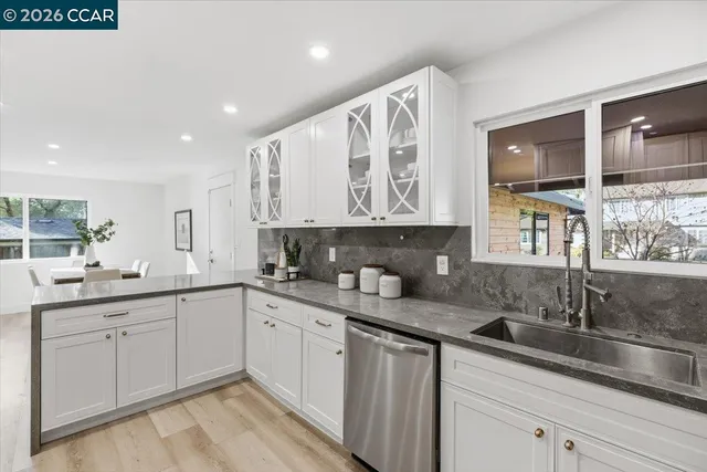 a kitchen with a sink stove and cabinets