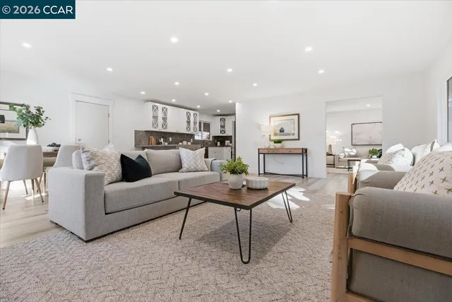 a living room with furniture and kitchen view