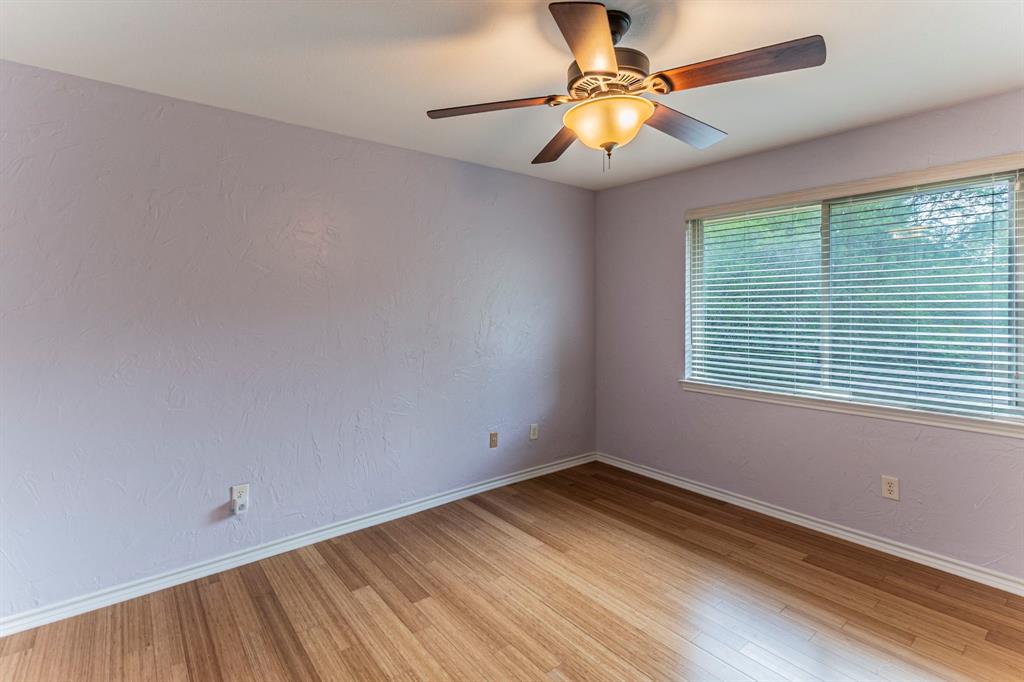 127 Nicklaus Nook Lancaster, TX 75146 - Photo 26 of 37 Unfurnished room featuring a ceiling fan, light wood-type flooring, and a textured wall