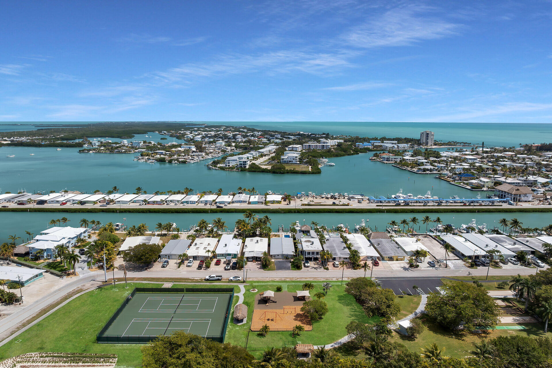 70 7th Street Key Colony Beach, FL 33051 - Photo 33 of 46 an aerial view of a city with lots of residential buildings and ocean view in back