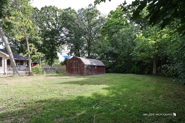 a yellow house in middle of the forest