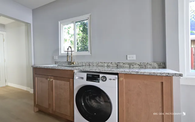 a view of a granite countertop sink and a window