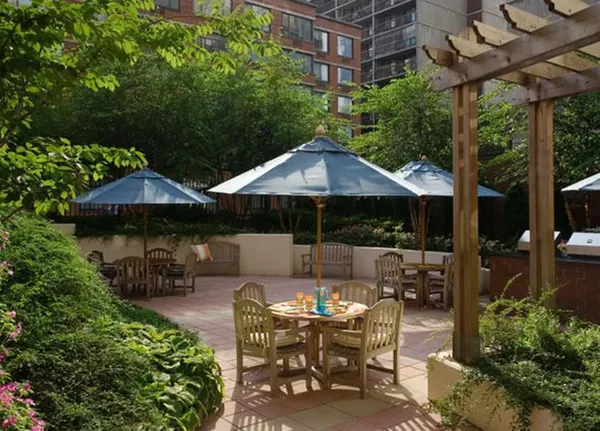 a view of patio with table and chairs under an umbrella