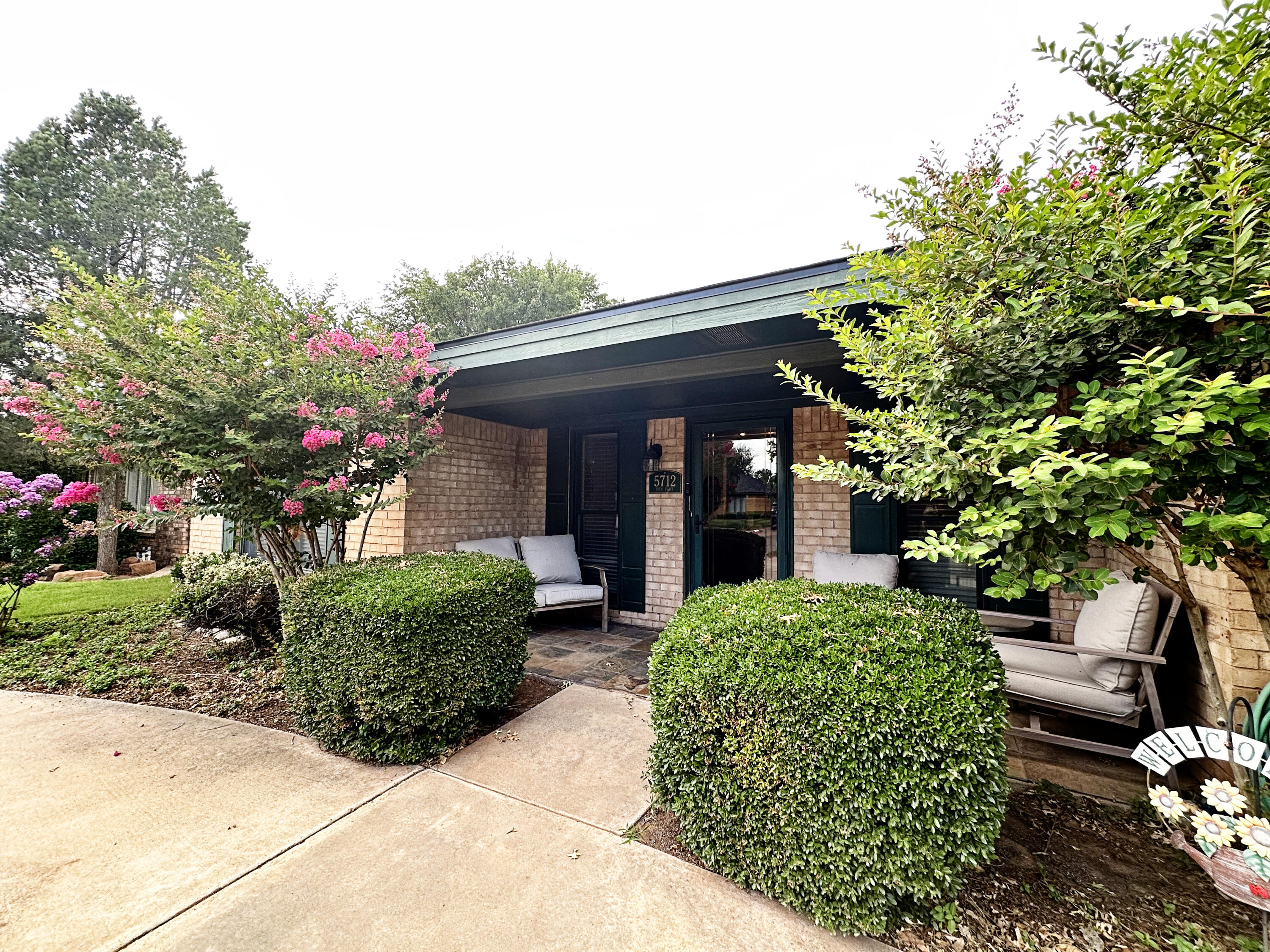 5712 70th Place Lubbock, TX 79424 - Photo 1 of 45 a front view of a house with garden