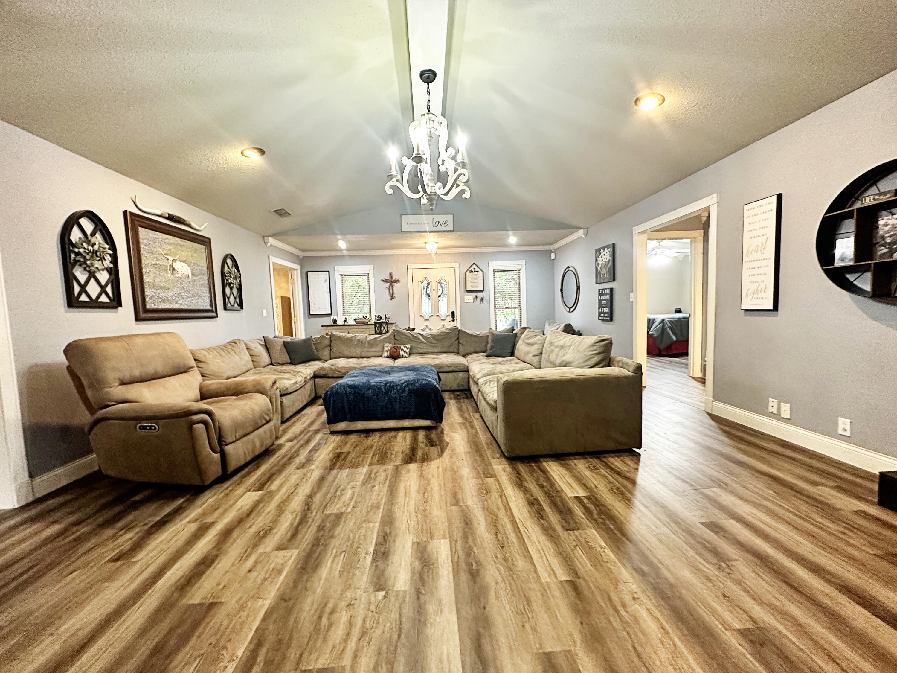 5712 70th Place Lubbock, TX 79424 - Photo 19 of 45 a living room with furniture and a chandelier