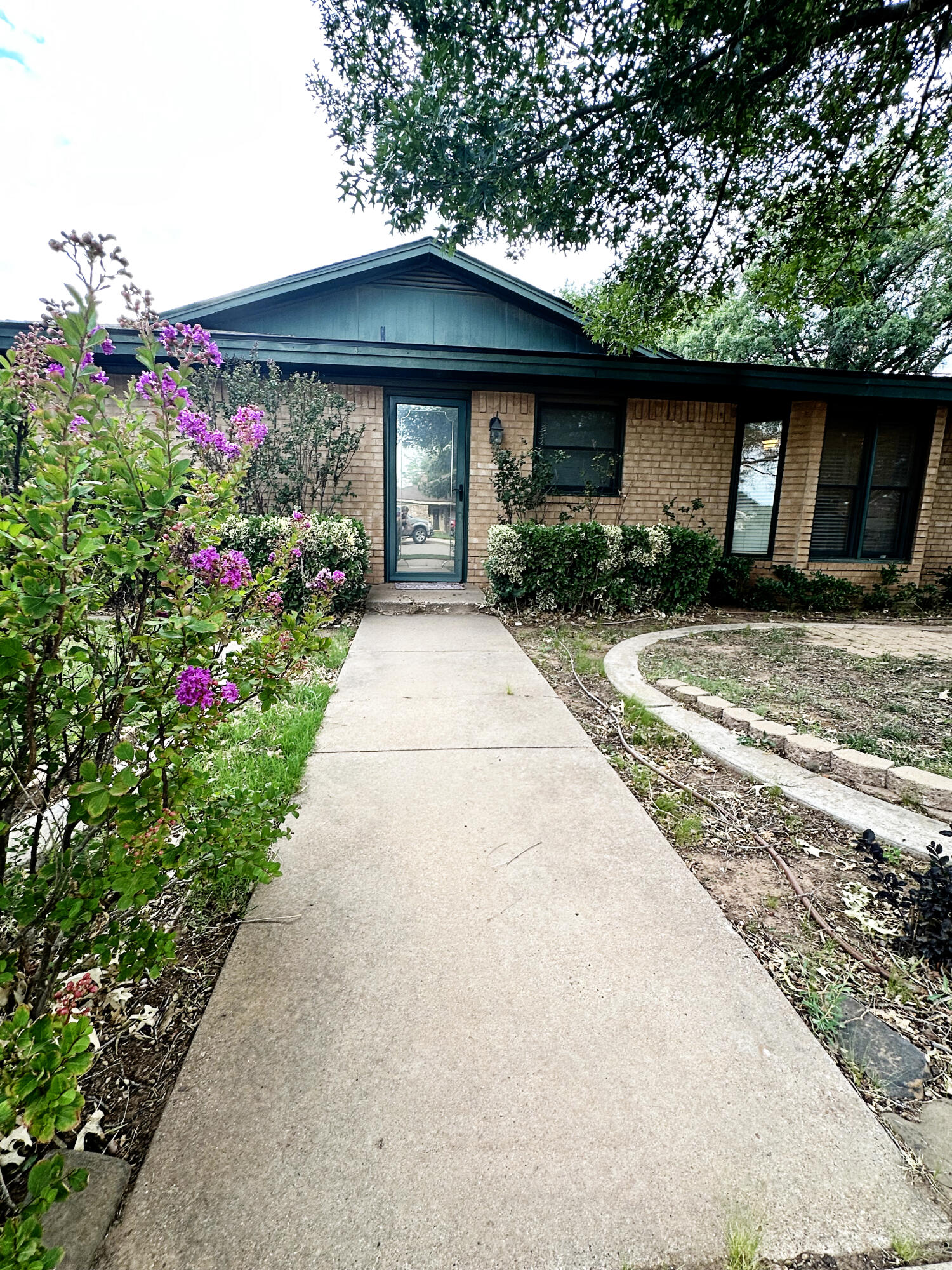 5712 70th Place Lubbock, TX 79424 - Photo 4 of 45 a front view of a house with a porch