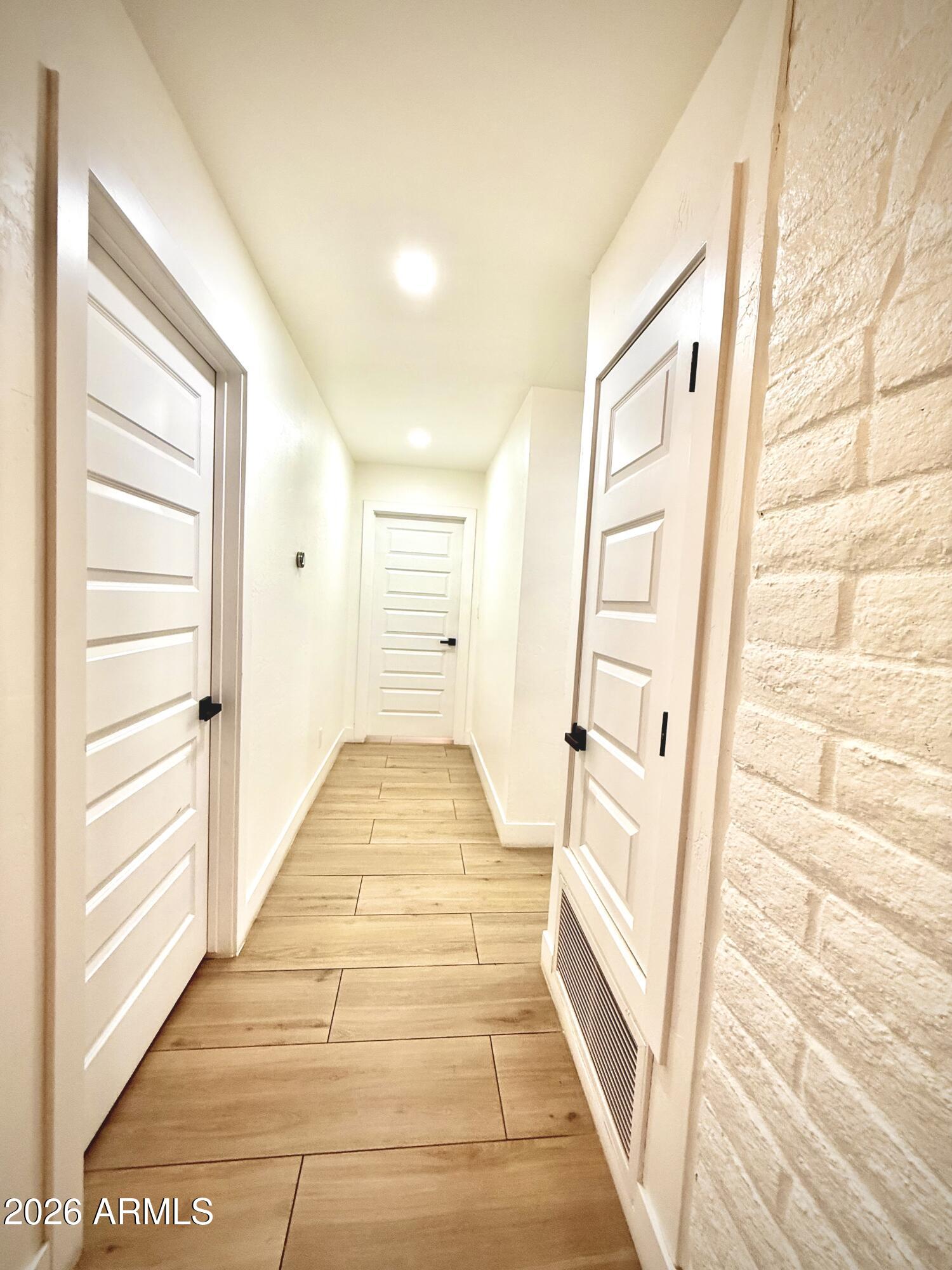 22 West Royal Palm Road Phoenix, AZ 85021 - Photo 18 of 26 a view of a hallway with wooden floor and entryway