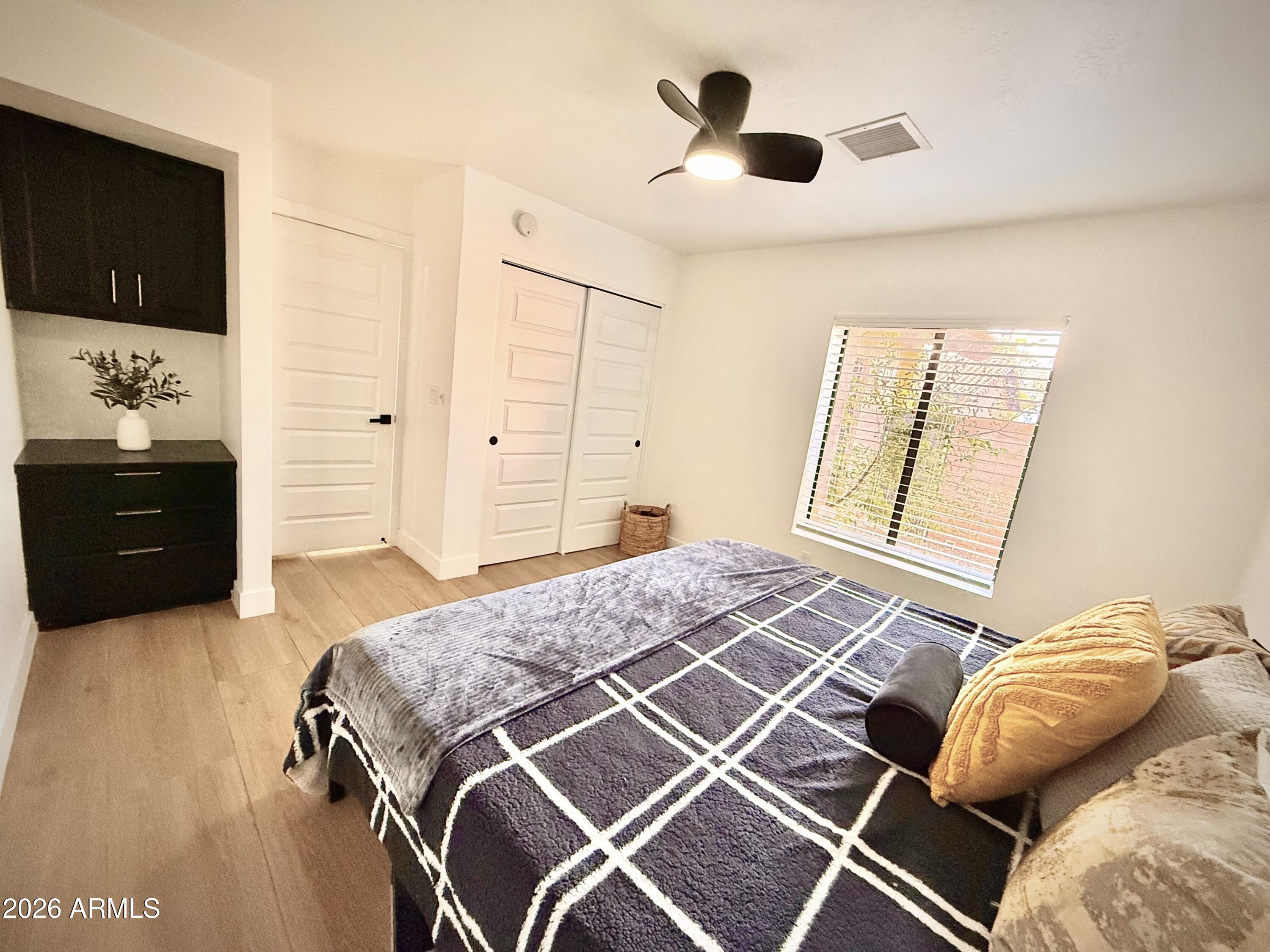 22 West Royal Palm Road Phoenix, AZ 85021 - Photo 19 of 26 a bedroom with a bed and a flat tv screen on a dresser