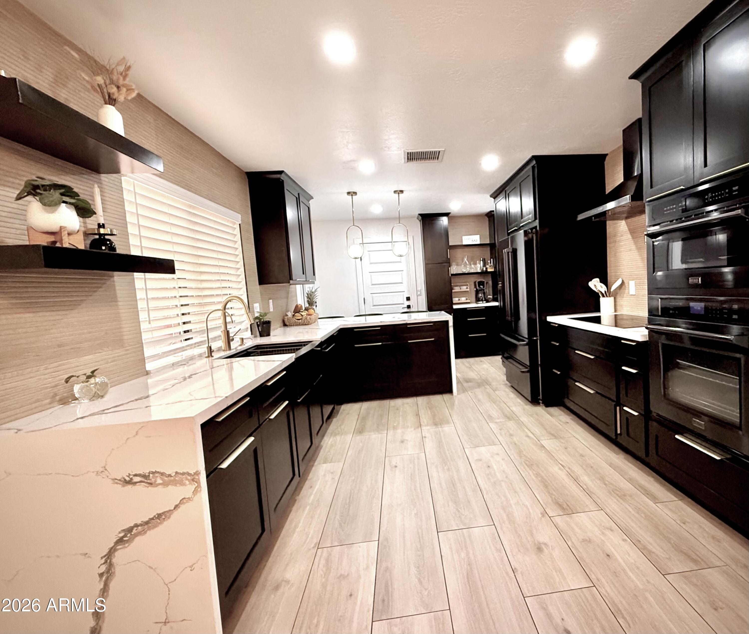 22 West Royal Palm Road Phoenix, AZ 85021 - Photo 6 of 26 a kitchen with stainless steel appliances kitchen island granite countertop a stove a sink and a refrigerator