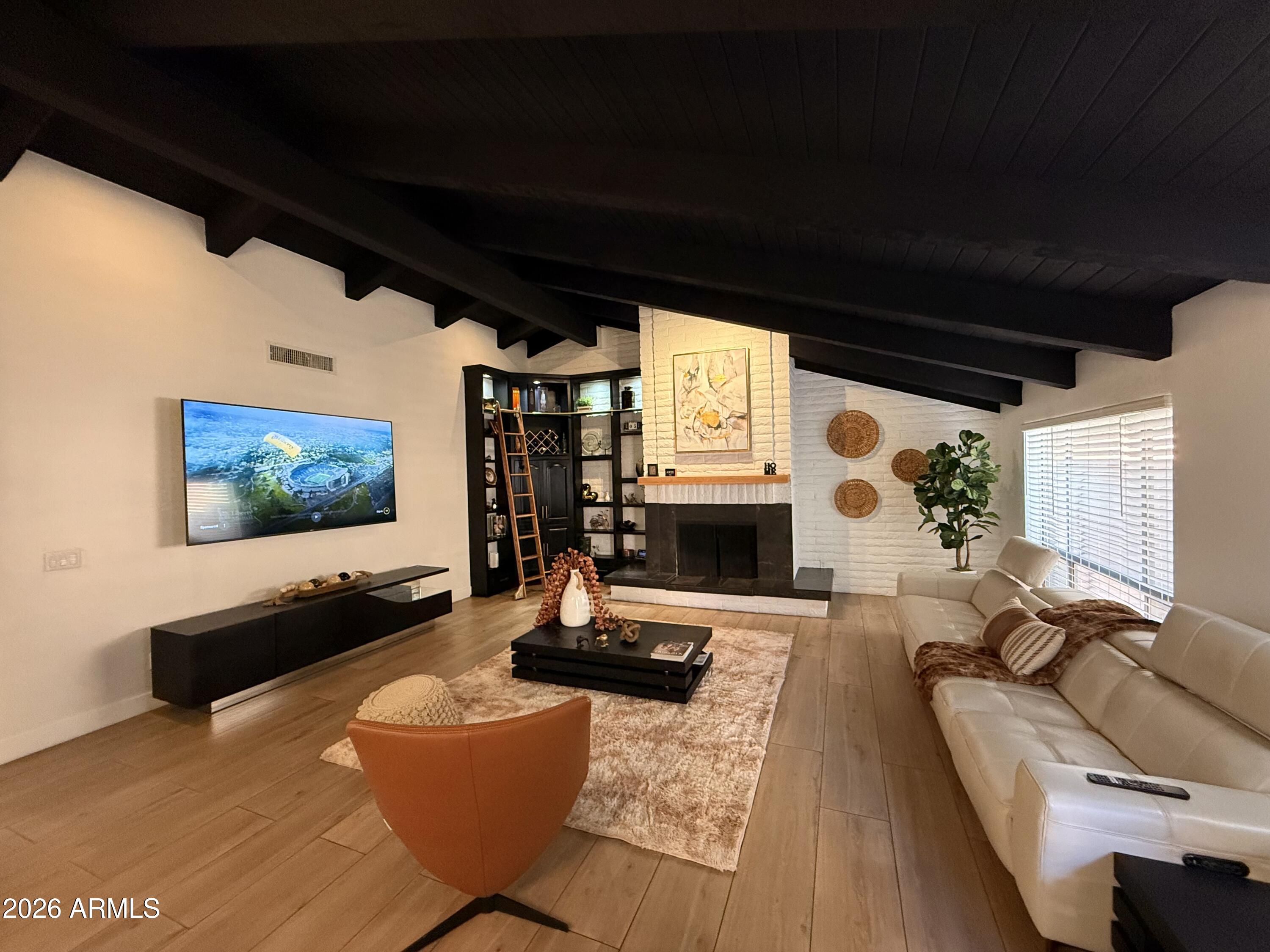 22 West Royal Palm Road Phoenix, AZ 85021 - Photo 10 of 26 a living room with furniture and a flat screen tv