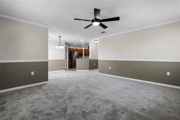 a view of a kitchen and a ceiling fan