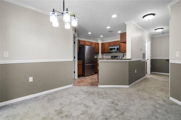 a view of a kitchen with stainless steel appliances granite countertop a refrigerator and a sink