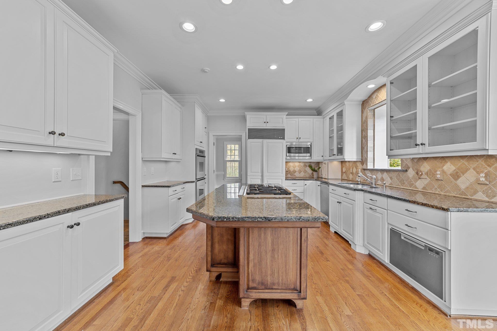 3101 Cornwall Road Durham, NC 27707 - Photo 11 of 30 a large kitchen with cabinets wooden floor and stainless steel appliances