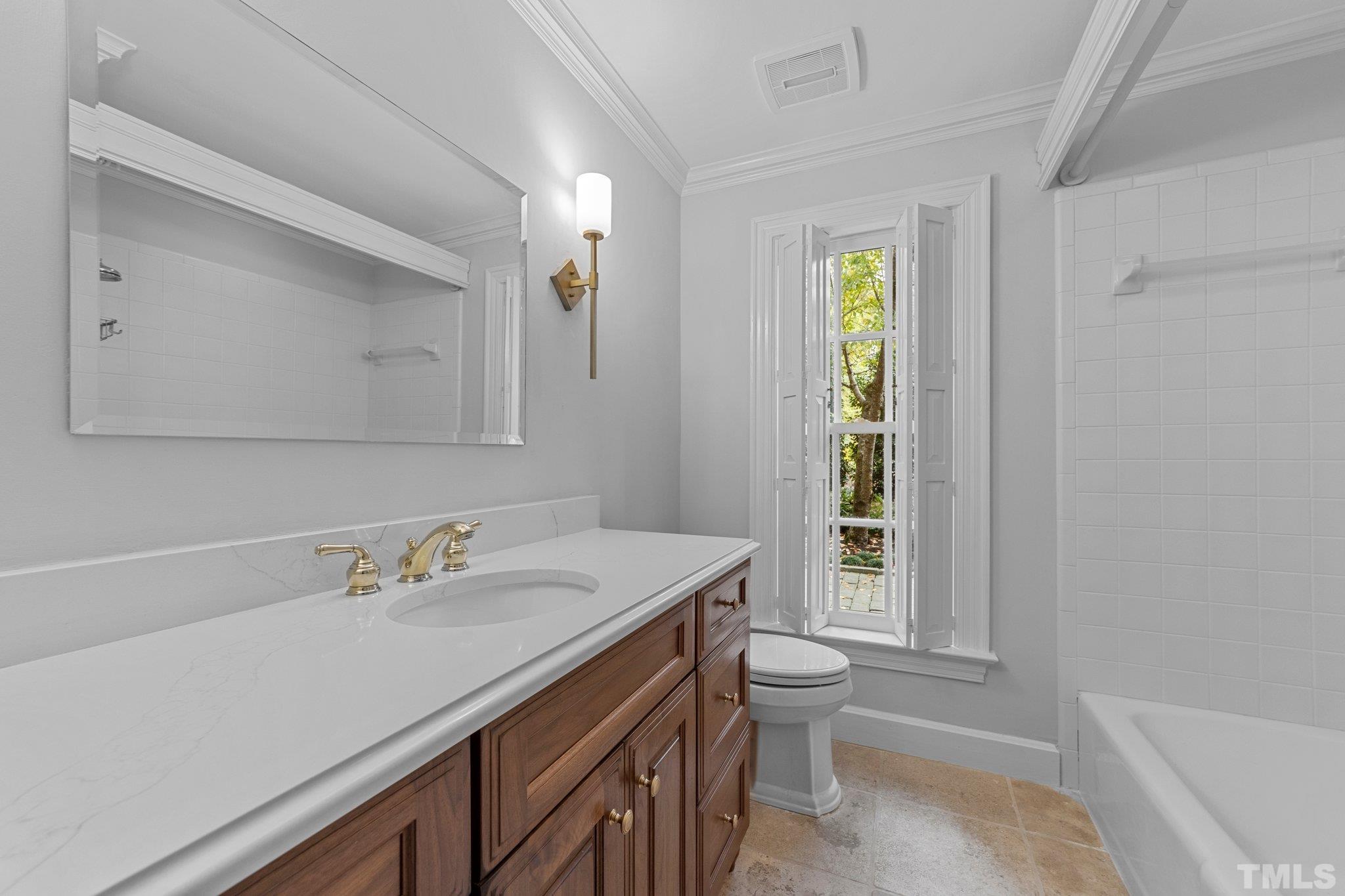 3101 Cornwall Road Durham, NC 27707 - Photo 28 of 30 a bathroom with a sink a toilet and window