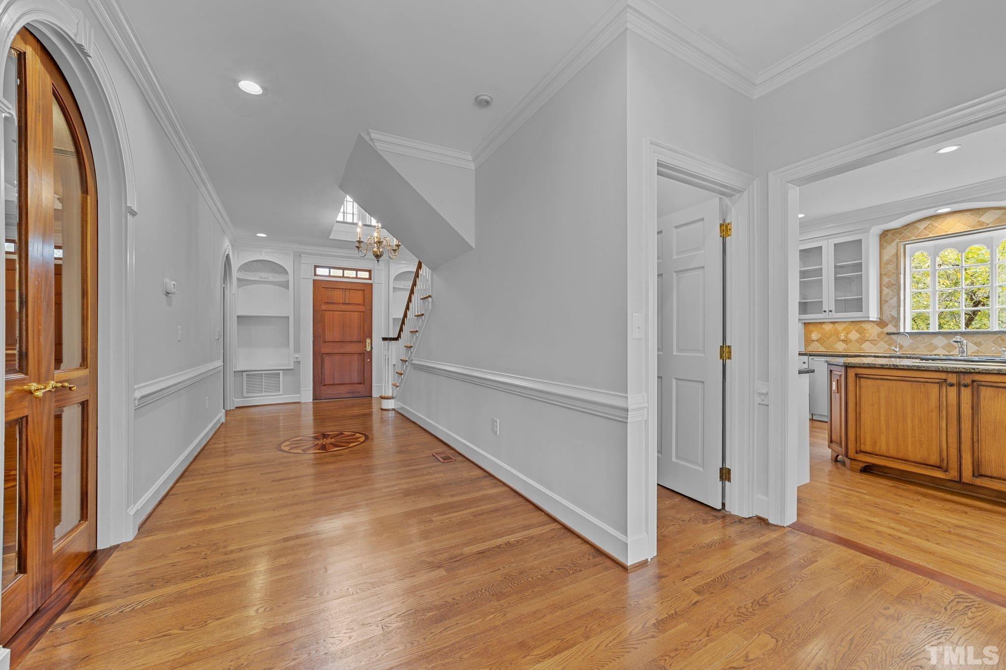 3101 Cornwall Road Durham, NC 27707 - Photo 7 of 30 a view of a hallway with wooden floor and a kitchen