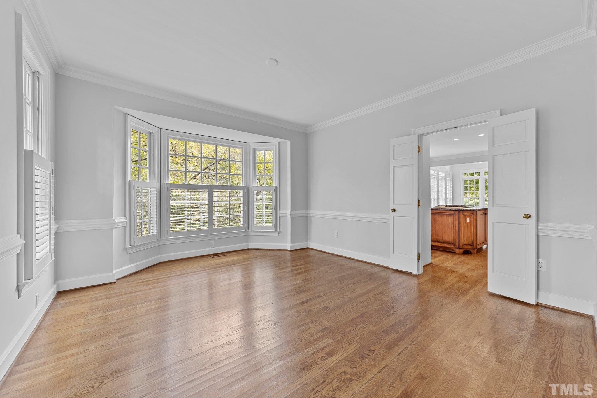 3101 Cornwall Road Durham, NC 27707 - Photo 9 of 30 an empty room with wooden floor and windows