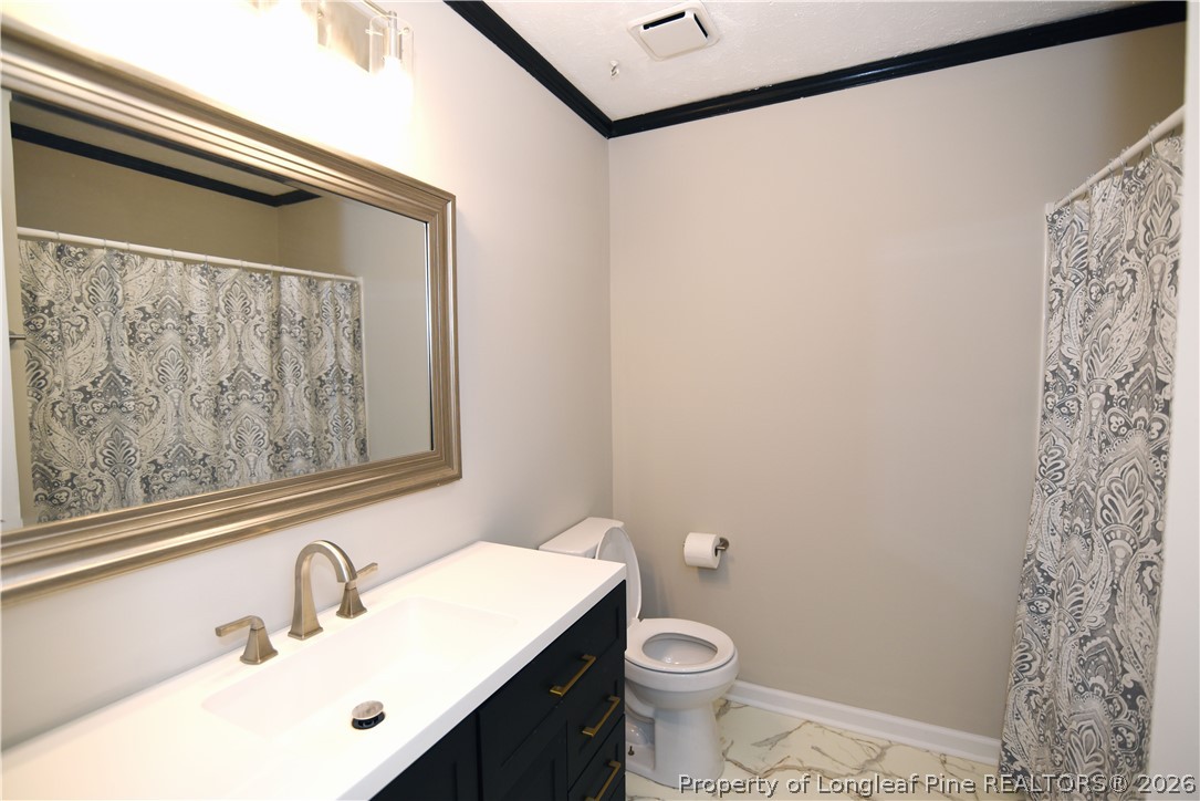 1673 Norment Road Lumberton, NC 28360 - Photo 24 of 32 a bathroom with a sink and a mirror
