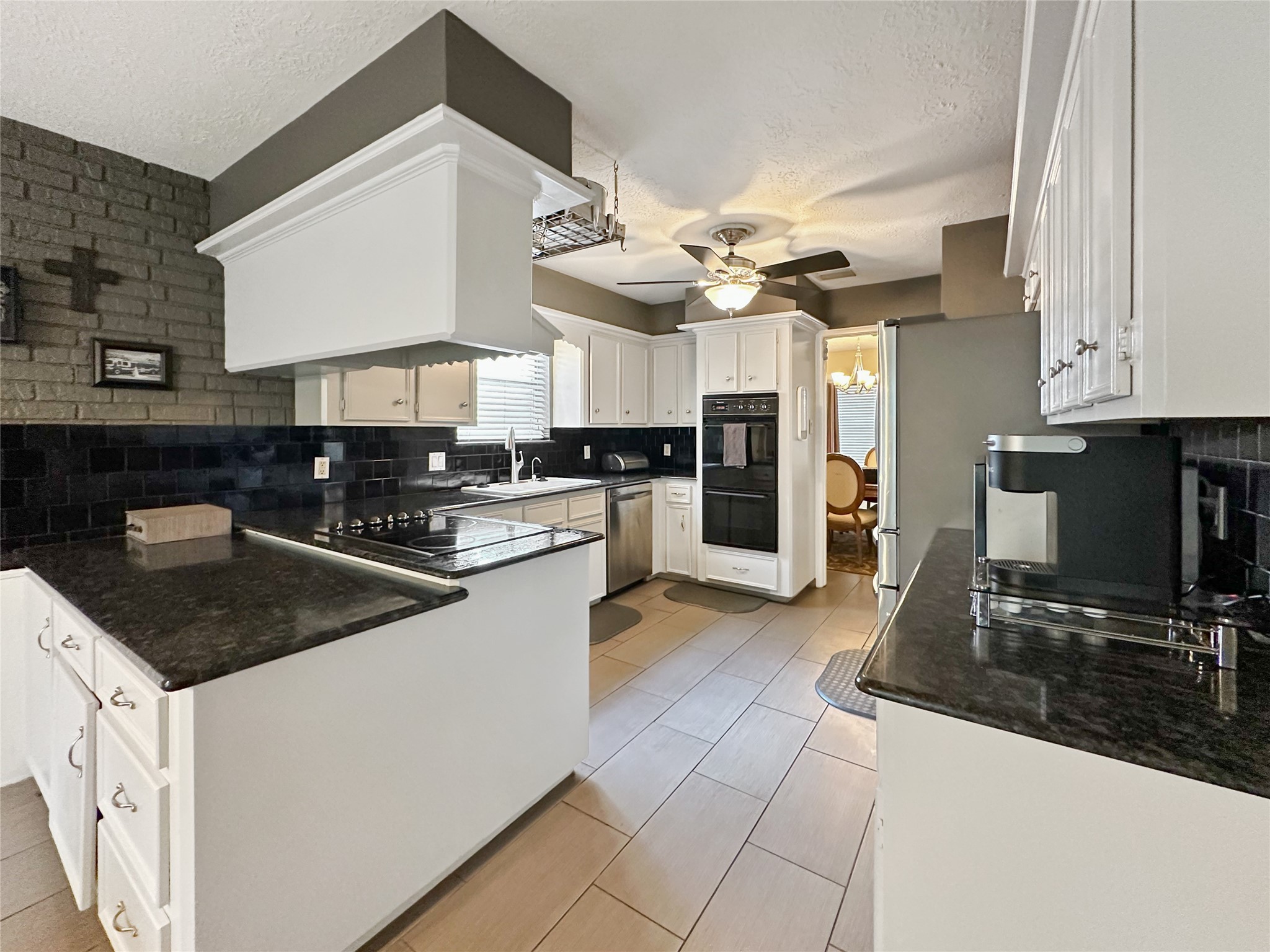 17407 Majestic Forest Drive Spring, TX 77379 - Photo 7 of 49 a kitchen with stainless steel appliances granite countertop a sink a stove and a refrigerator