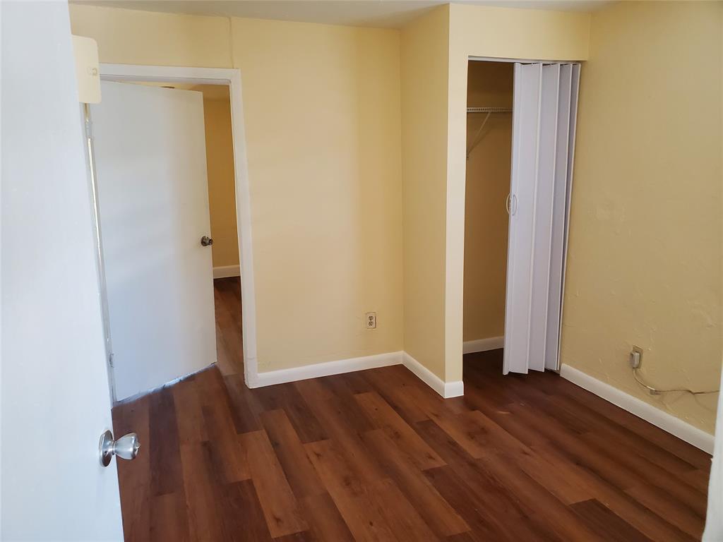 258 Adams Place, Unit 2 Pahokee, FL 33476 - Photo 11 of 25 an empty room with wooden floor and entrance