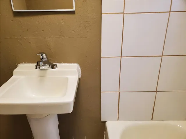 a bathroom with a sink and mirror