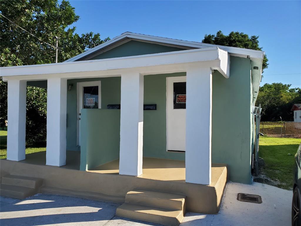258 Adams Place, Unit 2 Pahokee, FL 33476 - Photo 24 of 25 a front view of a house with outdoor space