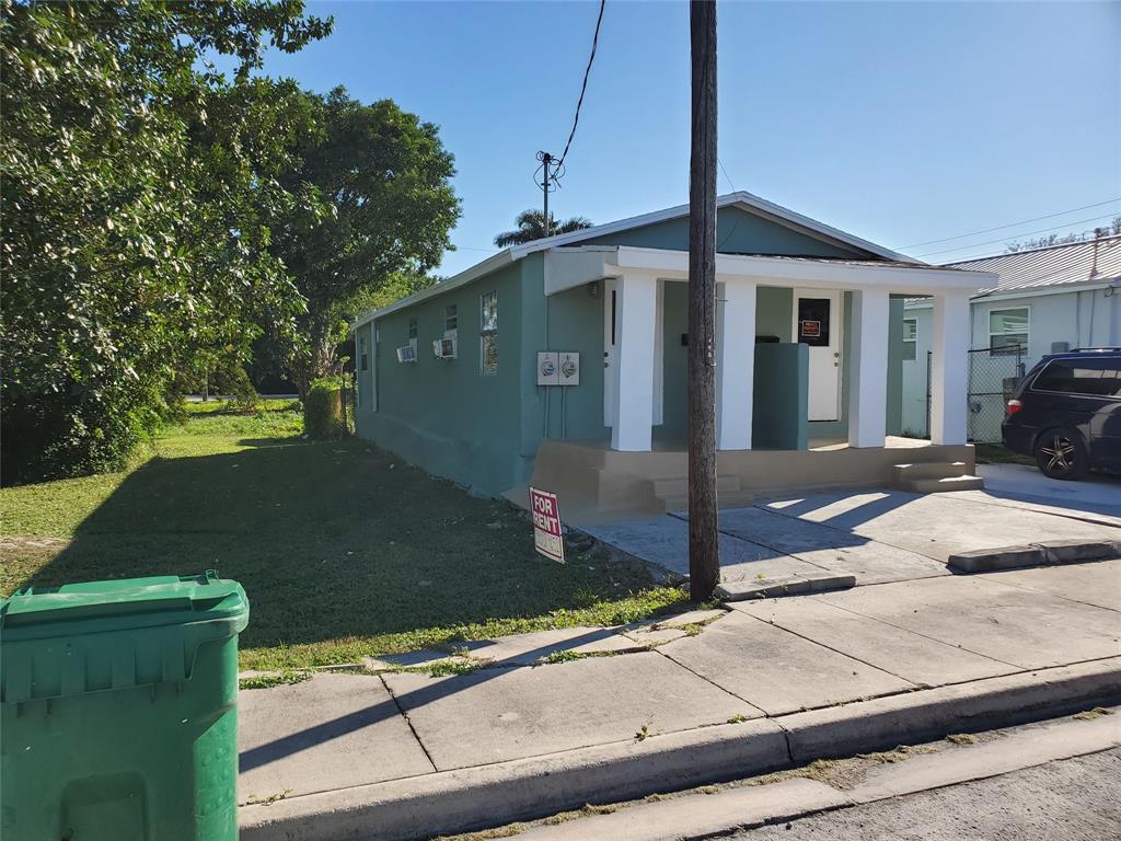 258 Adams Place, Unit 2 Pahokee, FL 33476 - Photo 3 of 25 a front view of a house with garden