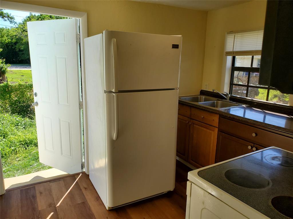 258 Adams Place, Unit 2 Pahokee, FL 33476 - Photo 6 of 25 a kitchen with stainless steel appliances granite countertop a refrigerator and a sink