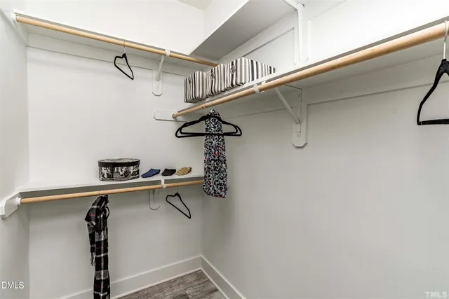 a bathroom with a granite countertop sink a mirror and shower