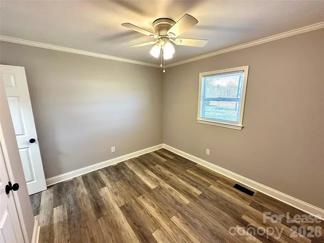 a view of a room with rack on the wall and a window