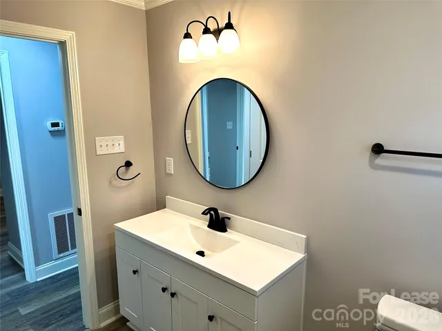 a white toilet sitting next to a window