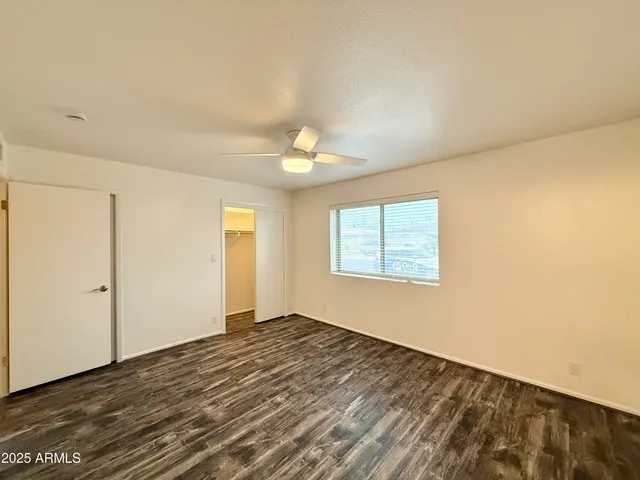 a bathroom with a granite countertop sink a toilet and bathtub