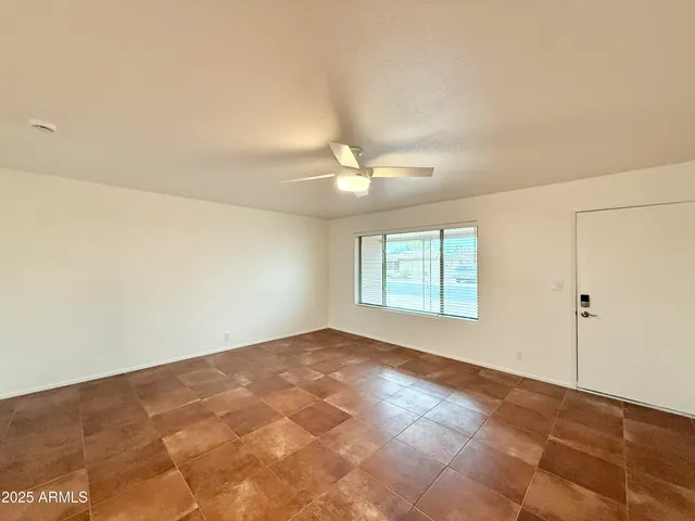an empty room with wooden floor and door