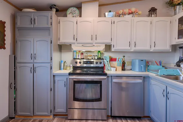 a kitchen with stainless steel appliances granite countertop a sink and cabinets with wooden floors
