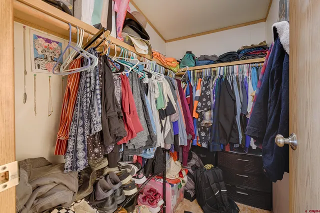 a bedroom with a bed and large mirror