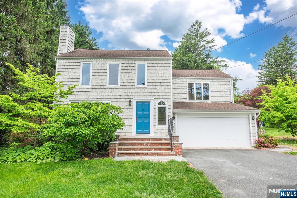 163 Sand Spring Road Morristown, NJ 07960 - Photo 2 of 39 a front view of a house with a garden
