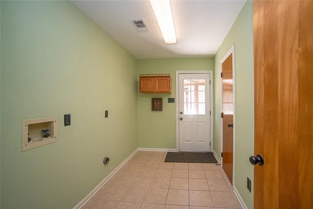 a view of a livingroom with wooden floor and windows
