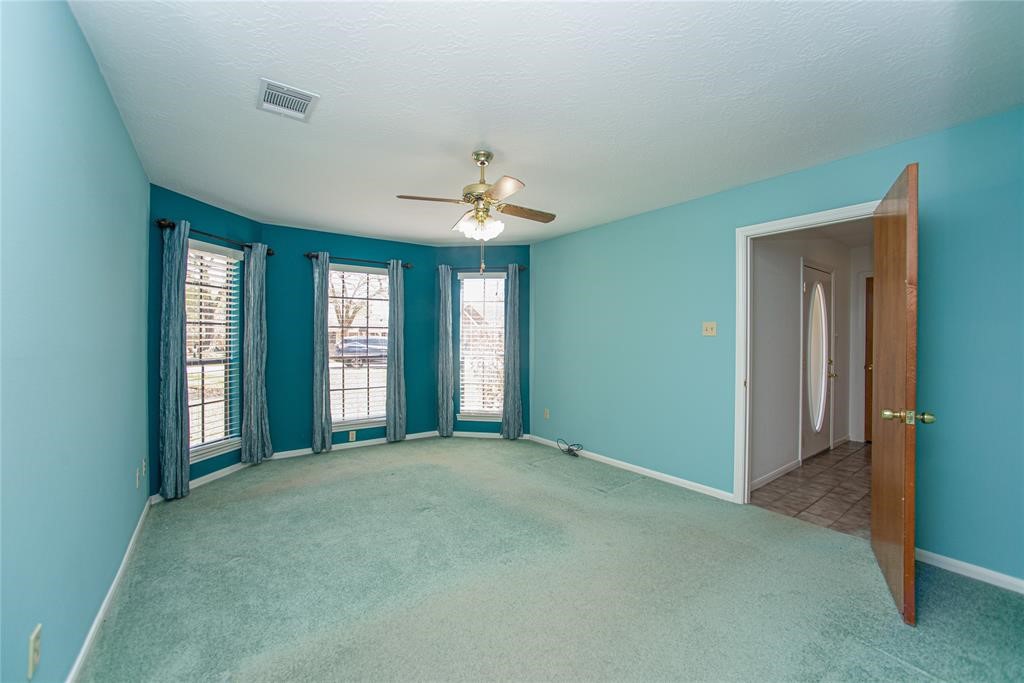 28816 South Diamondhead Conroe, TX 77356 - Photo 12 of 23 a view of an empty room with chandelier and a window
