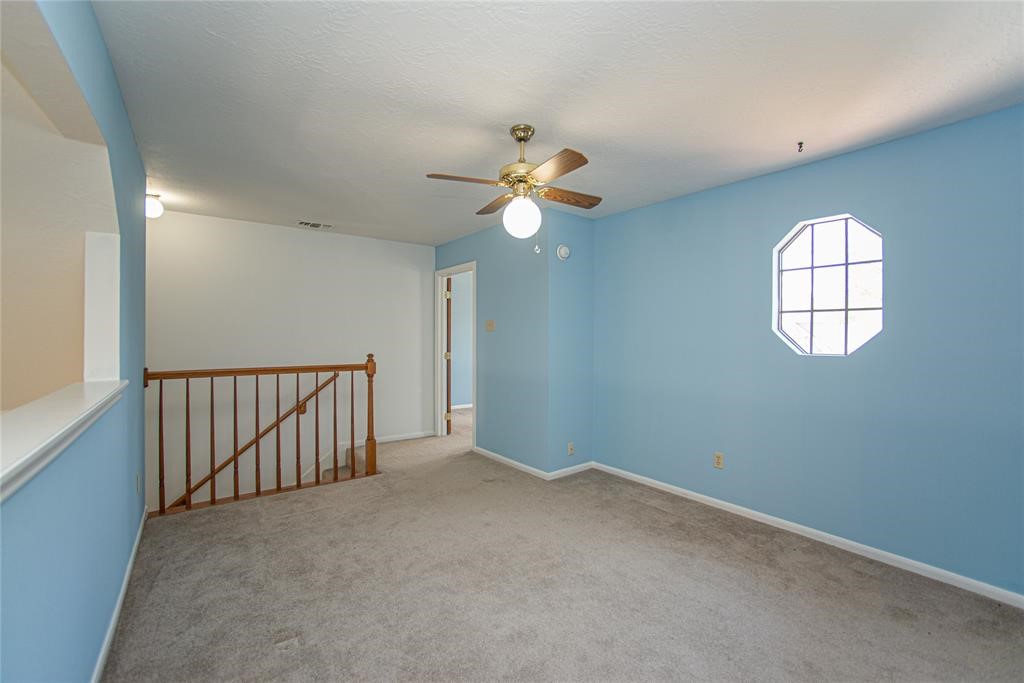 28816 South Diamondhead Conroe, TX 77356 - Photo 16 of 23 an empty room with windows and fan