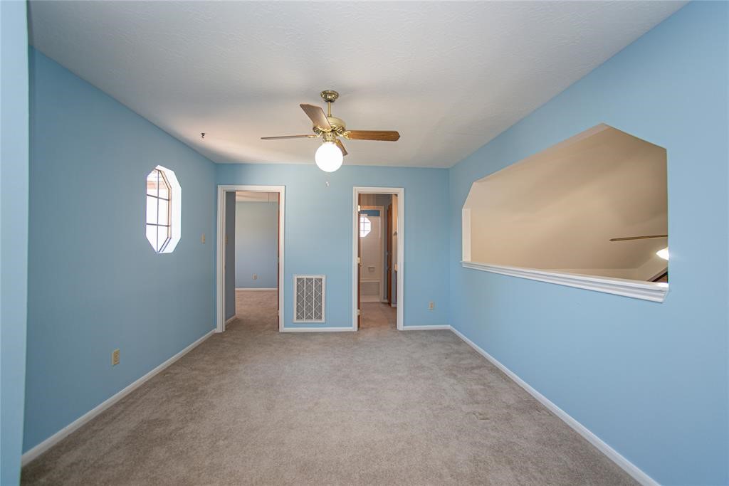 28816 South Diamondhead Conroe, TX 77356 - Photo 17 of 23 an empty room with windows and fan
