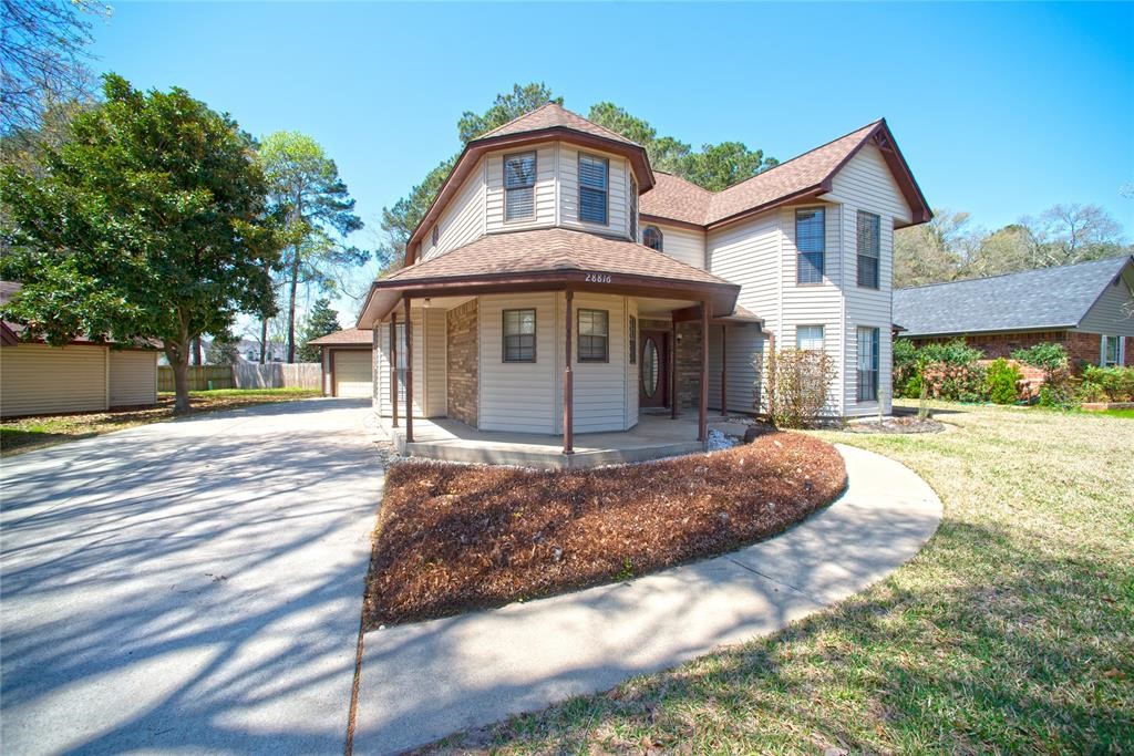 28816 South Diamondhead Conroe, TX 77356 - Photo 2 of 23 a front view of a house with a yard