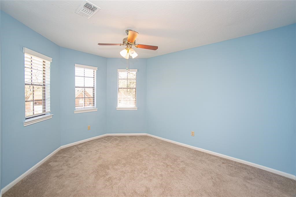 28816 South Diamondhead Conroe, TX 77356 - Photo 21 of 23 an empty room with windows and ceiling fan