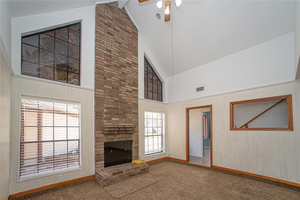 28816 South Diamondhead Conroe, TX 77356 - Photo 5 of 23 a view of an empty room with a fireplace and a window